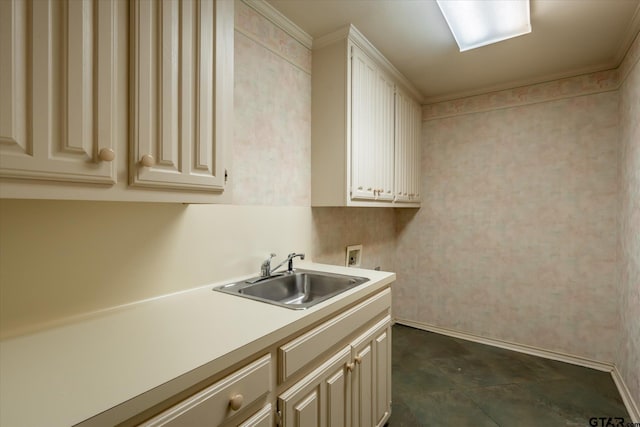 laundry area featuring hookup for a washing machine, cabinet space, ornamental molding, and a sink