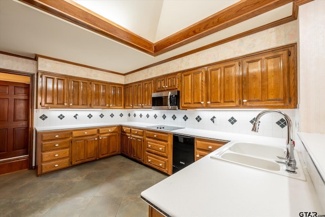 kitchen with black electric cooktop, stainless steel microwave, brown cabinetry, and a sink