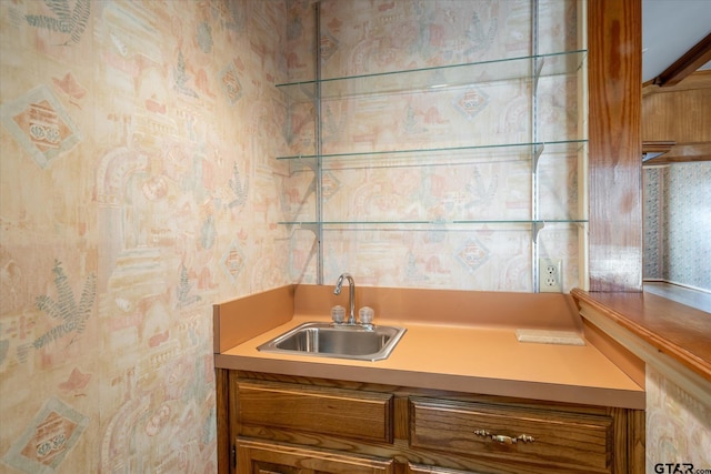 interior space with a sink and wallpapered walls