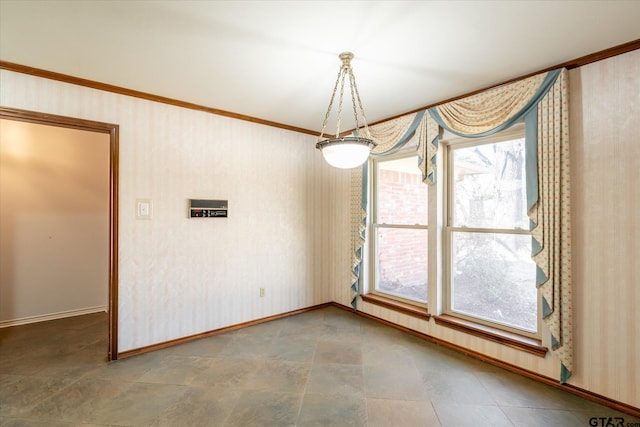 unfurnished dining area with wallpapered walls and baseboards