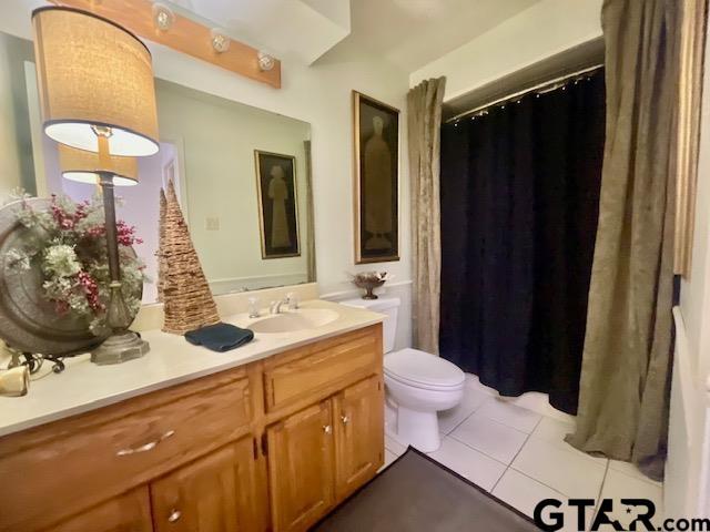 bathroom featuring tile patterned floors, vanity, and toilet