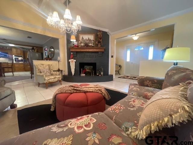 tiled living room featuring a notable chandelier, a large fireplace, ornamental molding, and vaulted ceiling