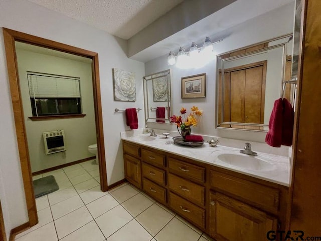 bathroom featuring vanity, tile patterned floors, toilet, a textured ceiling, and heating unit