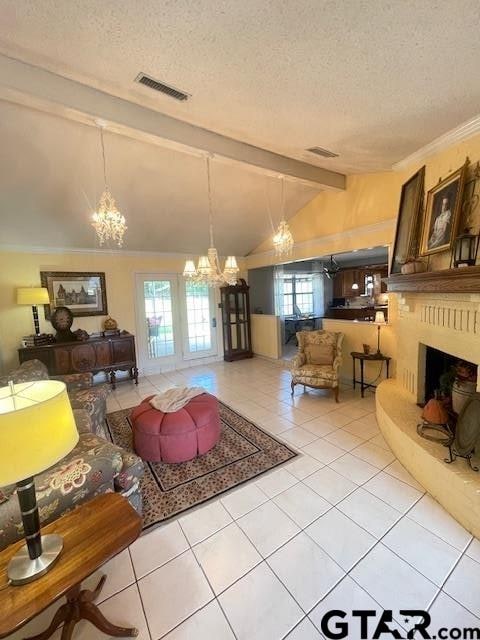 tiled living room featuring a textured ceiling, lofted ceiling with beams, and french doors