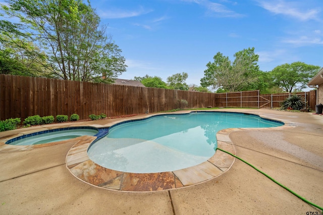 view of swimming pool featuring a patio area, a pool with connected hot tub, and a fenced backyard
