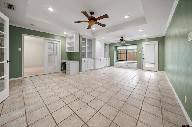 unfurnished living room with ornamental molding, a raised ceiling, recessed lighting, and a ceiling fan