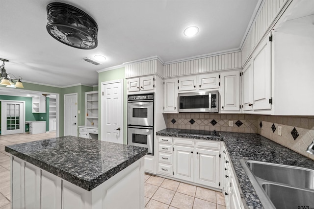 kitchen featuring stainless steel appliances, white cabinets, visible vents, and a sink