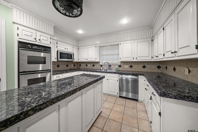 kitchen featuring stainless steel appliances, white cabinets, and a sink