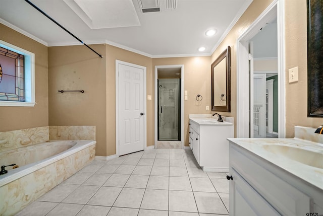 full bathroom featuring a sink, two vanities, tile patterned floors, a stall shower, and a garden tub