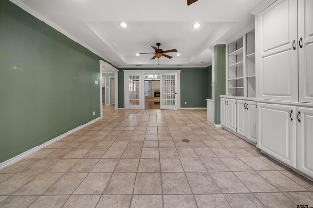 spare room featuring french doors, baseboards, a raised ceiling, and ceiling fan