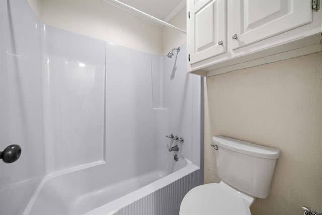 bathroom with toilet and bathing tub / shower combination