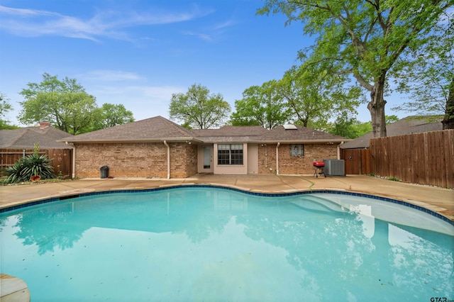 view of swimming pool with central air condition unit, a patio area, a fenced in pool, and fence