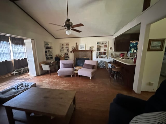 living room with a fireplace, hardwood / wood-style flooring, ceiling fan, and lofted ceiling