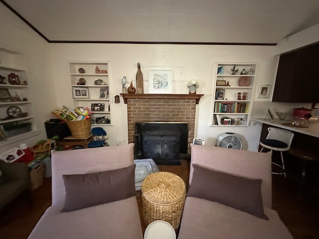 living room featuring a brick fireplace, built in features, and dark hardwood / wood-style flooring