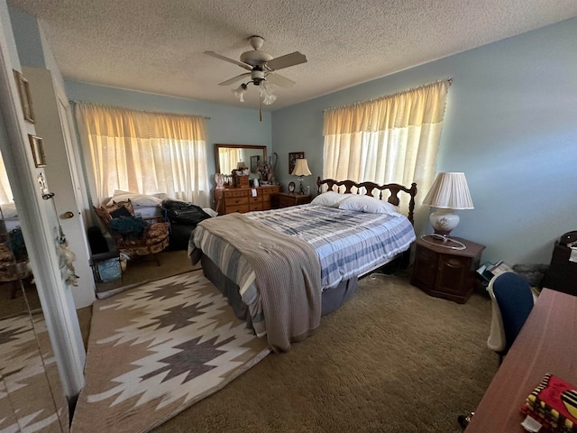 carpeted bedroom featuring a textured ceiling and ceiling fan