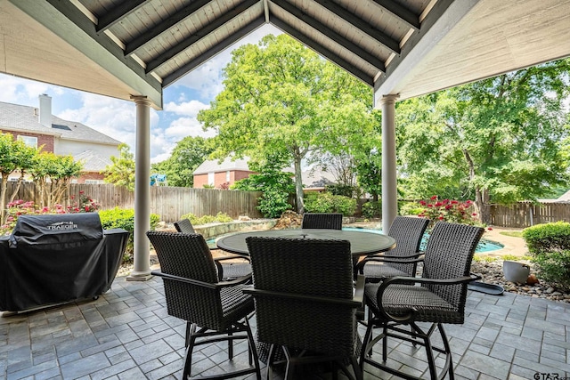 view of patio featuring area for grilling, a fenced backyard, and outdoor dining space