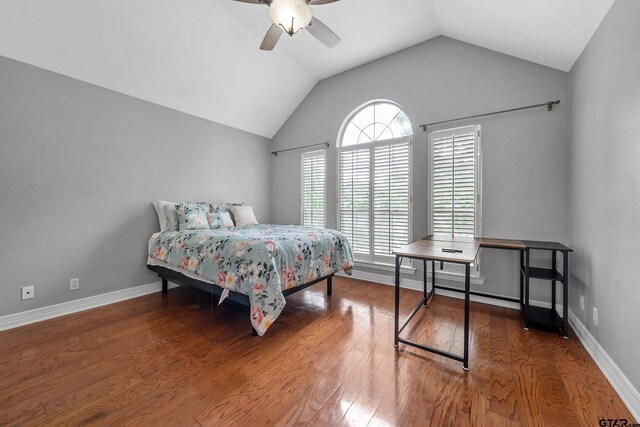 bedroom with lofted ceiling, baseboards, wood finished floors, and ceiling fan