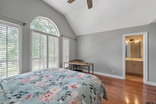 bedroom with a sink, ceiling fan, light wood finished floors, baseboards, and lofted ceiling