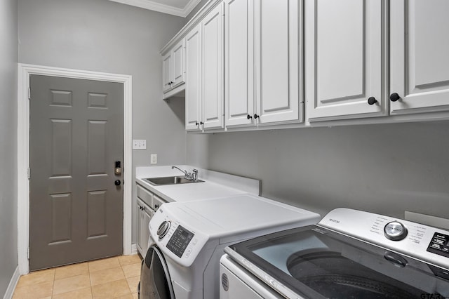 laundry area featuring a sink, separate washer and dryer, light tile patterned floors, cabinet space, and ornamental molding