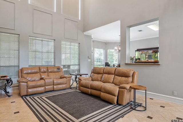 living area featuring a towering ceiling, baseboards, a notable chandelier, crown molding, and light tile patterned floors