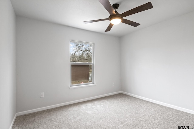 empty room featuring ceiling fan, carpet flooring, and baseboards