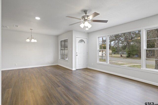 interior space featuring dark wood-style floors, visible vents, and baseboards