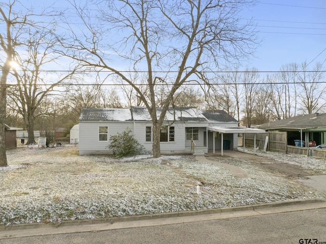 view of front of house featuring an attached carport, crawl space, fence, and concrete driveway