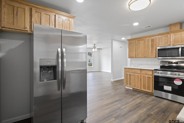 kitchen featuring baseboards, visible vents, dark wood-style floors, ceiling fan, and stainless steel appliances