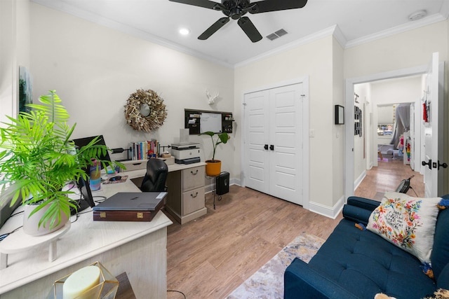 office space featuring light wood-type flooring, ceiling fan, and ornamental molding