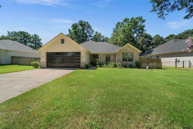 view of front of property featuring a garage and a front lawn