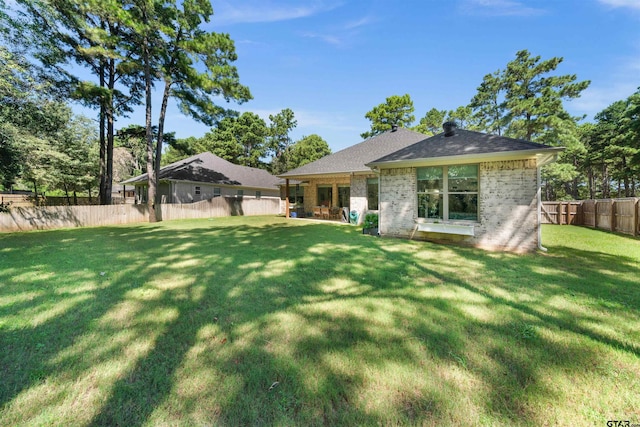 back of house with a yard