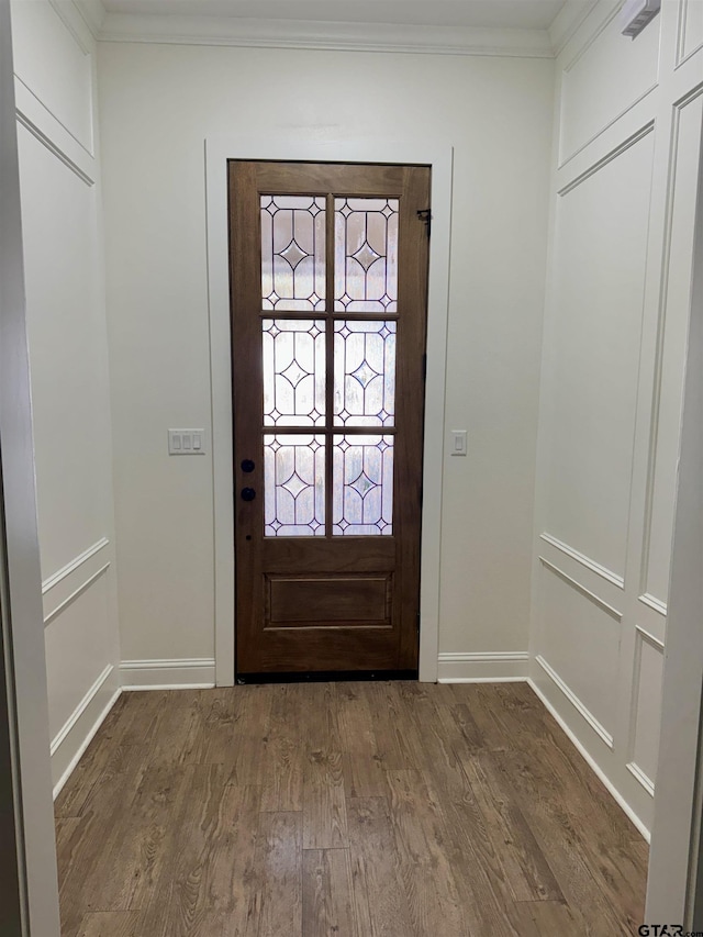 entrance foyer featuring french doors, wood-type flooring, and ornamental molding