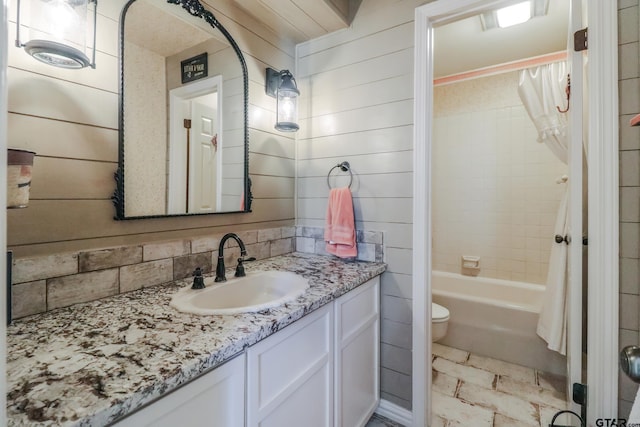 full bathroom featuring vanity, backsplash, toilet, and shower / bath combo with shower curtain