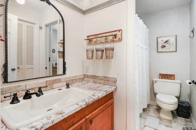 bathroom featuring tasteful backsplash, vanity, and toilet