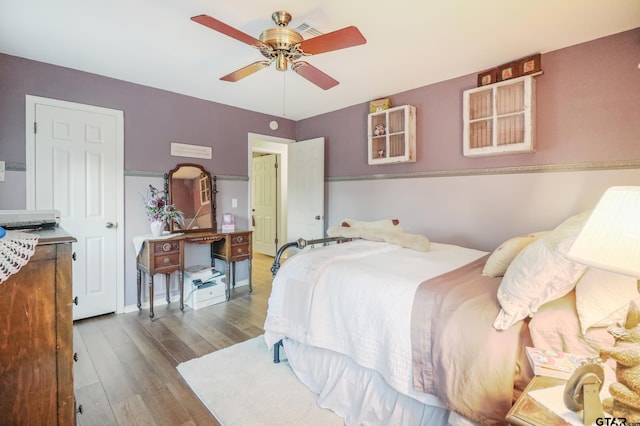 bedroom featuring hardwood / wood-style floors and ceiling fan