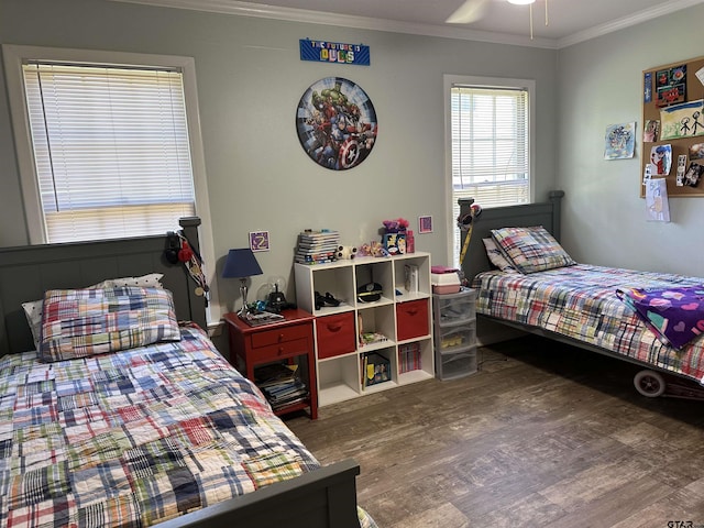 bedroom featuring ceiling fan, dark hardwood / wood-style flooring, and ornamental molding