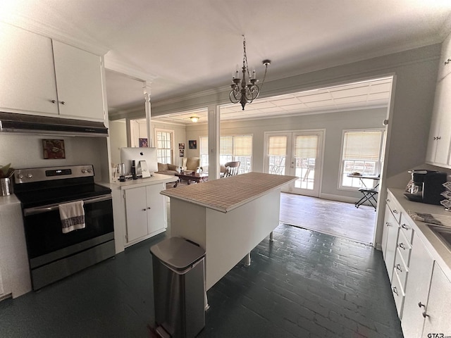 kitchen with white cabinets, a notable chandelier, stainless steel range with electric stovetop, and ornamental molding