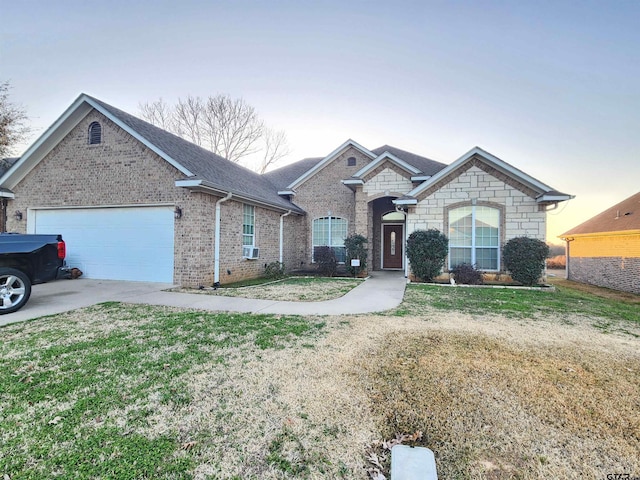 single story home with cooling unit, a garage, and a yard