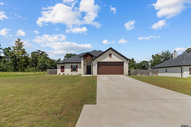 view of front of property with a front yard and a garage