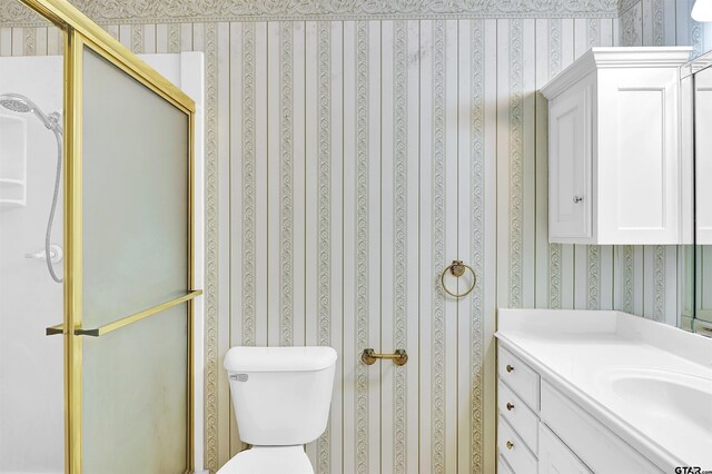 507 Tullie Dr, Longview, TX 75601 - bathroom with wallpapered walls, vanity, a stall shower, and toilet