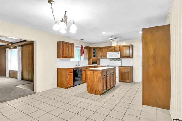 507 Tullie Dr, Longview, TX 75601 - kitchen featuring white appliances, brown cabinetry, light countertops, a sink, and recessed lighting