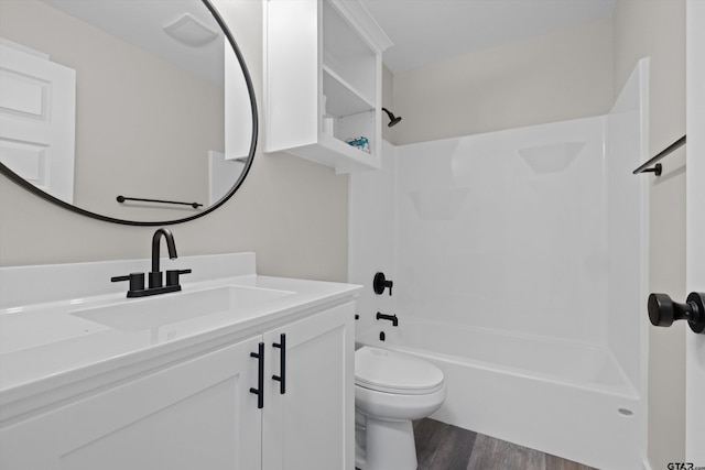 full bathroom featuring hardwood / wood-style flooring, toilet, shower / tub combination, and vanity