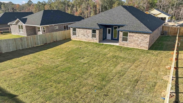 rear view of house featuring a yard