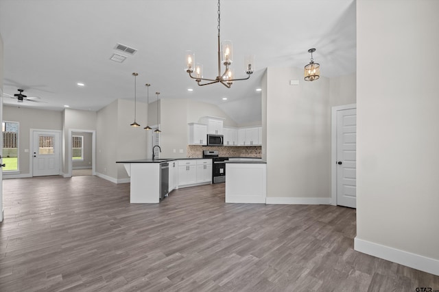 kitchen featuring appliances with stainless steel finishes, white cabinets, a kitchen island, light wood-type flooring, and pendant lighting