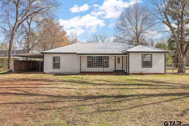 ranch-style house with a carport and a front yard