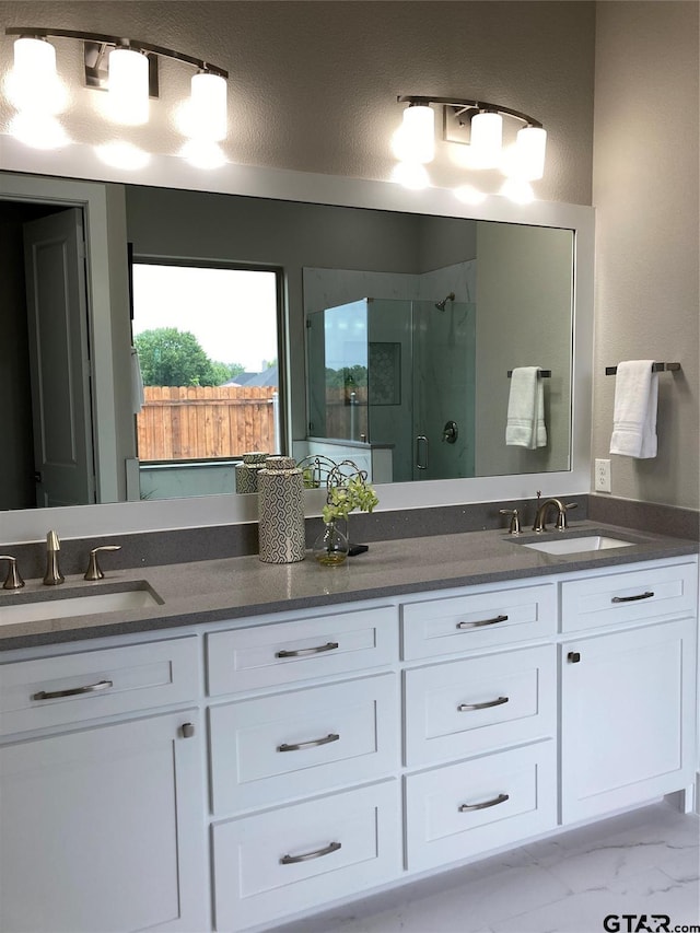 bathroom featuring vanity, a shower with door, and a textured ceiling