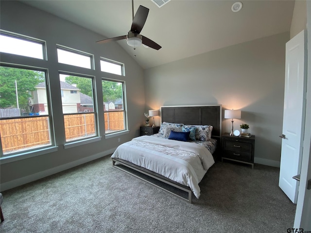 bedroom with ceiling fan, dark carpet, and vaulted ceiling