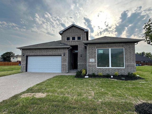 view of front of home with a garage and a front lawn