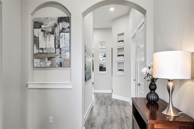 corridor with hardwood / wood-style flooring