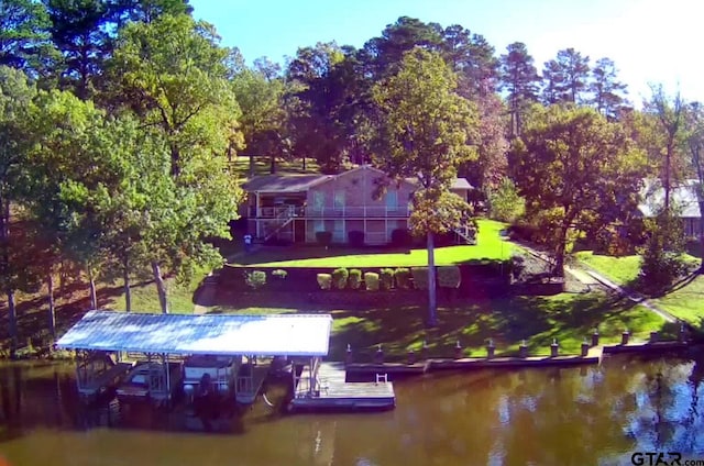 view of dock featuring a yard and a water view